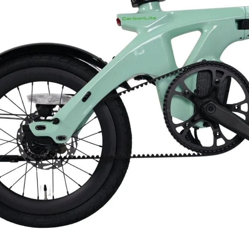 CarbonLite folding e‑bike front and rear integrated lights illuminated in urban setting
